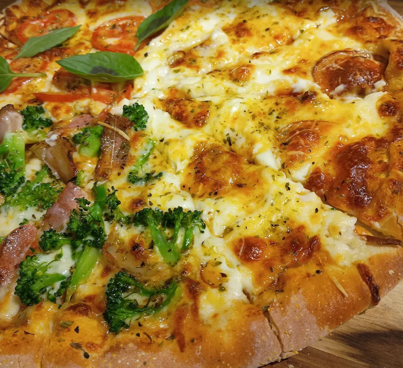 Pizza dourada da A Forneria 1984 com sabores variados
